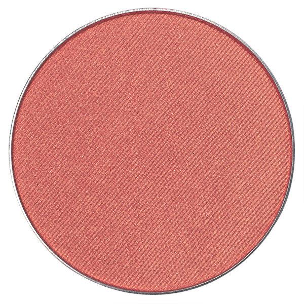 "Pressed powder blush flatlay with makeup brush"