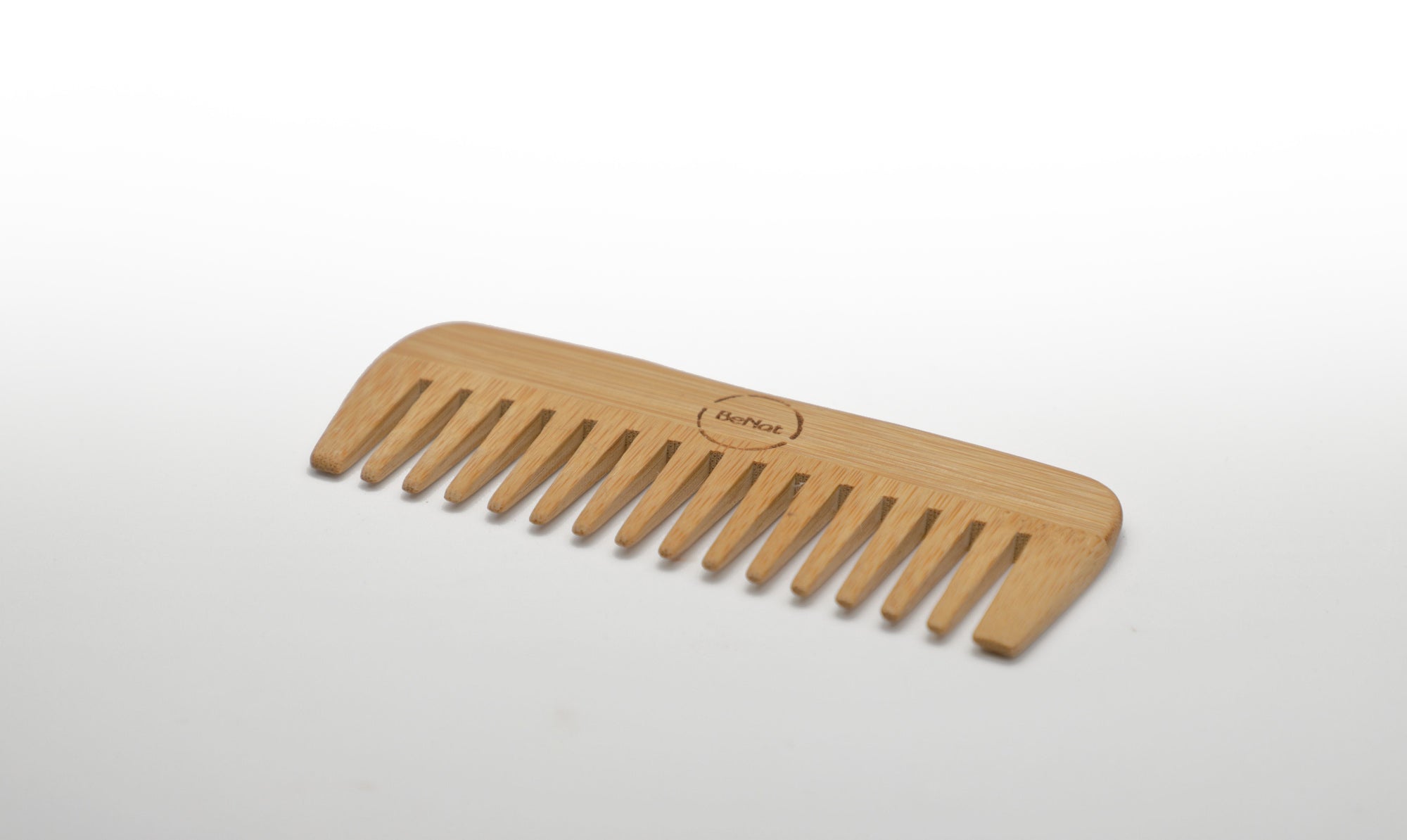 "Bamboo hair comb shown detangling hair"
