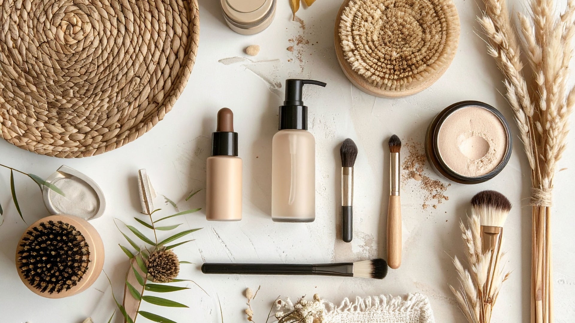 Natural beauty makeup products with brushes serum and powder flatlay